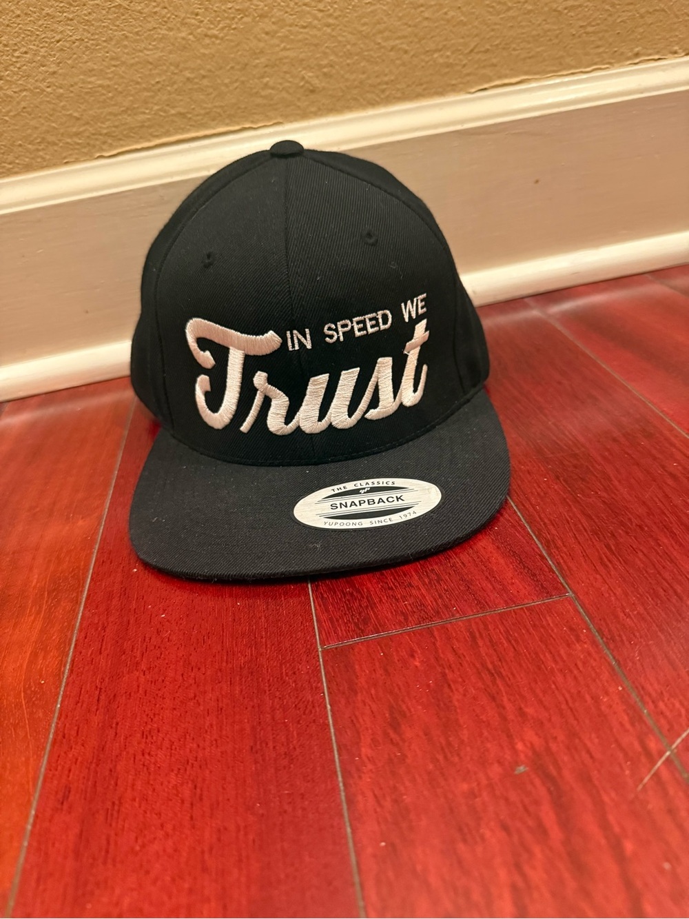 The Classic Black 'In Speed We Trust' Snapback Hat